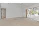 Main bedroom with carpeted floors, sliding glass doors to a patio, and a mirrored closet at 4572 Woodcove Dr, Port Orange, FL 32127