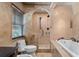 Luxurious bathroom features a soaking tub, walk-in shower with pebble floor, and high-end fixtures, offering a spa-like experience at 4914 Gran Lac Ave, Belle Isle, FL 32812