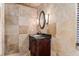 Elegant bathroom with granite countertop, custom vanity, and tiled walls, creating a luxurious and refined space at 4914 Gran Lac Ave, Belle Isle, FL 32812