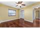 Bedroom features hardwood floors, ceiling fan, closet, and neutral walls at 4914 Gran Lac Ave, Belle Isle, FL 32812