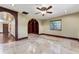 Bedroom with neutral tile floors, ceiling fan, recessed lights, and arched entry at 4914 Gran Lac Ave, Belle Isle, FL 32812