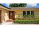 The front entry displays a wood door, manicured hedges, and updated window at 4914 Gran Lac Ave, Belle Isle, FL 32812