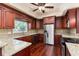 Well-equipped kitchen featuring stainless steel appliances, granite countertops, and wooden cabinets at 4914 Gran Lac Ave, Belle Isle, FL 32812