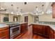 Spacious kitchen featuring granite counters, wood cabinets, and stainless steel appliances at 4914 Gran Lac Ave, Belle Isle, FL 32812