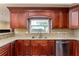 Close up of kitchen showing granite counters, stainless steel appliances and wood cabinets at 4914 Gran Lac Ave, Belle Isle, FL 32812