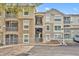Exterior view of condo building with parking and landscaping at 588 Brantley Terrace Way # 303, Altamonte Springs, FL 32714