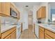 Eat-in kitchen with wood cabinets, microwave, and white appliances at 588 Brantley Terrace Way # 303, Altamonte Springs, FL 32714