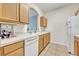 Bright kitchen with wood cabinets, white appliances, and tile floor at 588 Brantley Terrace Way # 303, Altamonte Springs, FL 32714