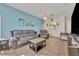 Living room with gray sectional and light blue walls at 588 Brantley Terrace Way # 303, Altamonte Springs, FL 32714