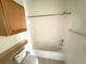Bathroom with a shower/tub combo and wood cabinet at 6149 Metrowest Blvd # 106, Orlando, FL 32835
