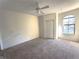 Bright bedroom featuring a ceiling fan and large window at 6149 Metrowest Blvd # 106, Orlando, FL 32835