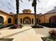 Elegant community entrance with arched walkways and lush landscaping at 6149 Metrowest Blvd # 106, Orlando, FL 32835
