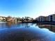 Waterfront community view with palm trees and Spanish-style buildings at 6149 Metrowest Blvd # 106, Orlando, FL 32835