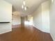 Bright dining room with hardwood floors and modern light fixture at 6149 Metrowest Blvd # 106, Orlando, FL 32835
