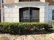 Building exterior with screened balcony and landscaping at 6149 Metrowest Blvd # 106, Orlando, FL 32835