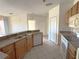 Kitchen with light wood cabinets and stainless steel appliances at 6149 Metrowest Blvd # 106, Orlando, FL 32835