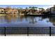 Tranquil lake view with lush landscaping and community buildings at 6149 Metrowest Blvd # 106, Orlando, FL 32835