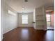Living room with hardwood floors and large window at 6149 Metrowest Blvd # 106, Orlando, FL 32835
