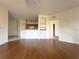 Spacious living room with hardwood floors and kitchen views at 6149 Metrowest Blvd # 106, Orlando, FL 32835