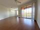 Bright living room featuring hardwood floors and access to balcony at 6149 Metrowest Blvd # 106, Orlando, FL 32835