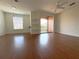 Living room with hardwood floors and balcony access at 6149 Metrowest Blvd # 106, Orlando, FL 32835