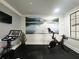 Private fitness room with Peloton bikes and scenic wall art at 6149 Metrowest Blvd # 106, Orlando, FL 32835