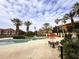 Relaxing resort-style pool with patio furniture and umbrellas at 6149 Metrowest Blvd # 106, Orlando, FL 32835