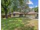 Spacious backyard with lush lawn and mature trees, perfect for outdoor entertaining at 630 Sailfish Rd, Winter Springs, FL 32708