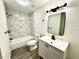 Beautiful renovated bathroom with new vanity, marble-style tile, and modern fixtures at 630 Sailfish Rd, Winter Springs, FL 32708