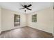 Bright bedroom with wood-look floors and two windows at 630 Sailfish Rd, Winter Springs, FL 32708