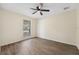 Well-lit bedroom featuring wood-look floors and large window at 630 Sailfish Rd, Winter Springs, FL 32708