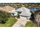 Single-Gathering home with a paved driveway and a lake view in a quiet neighborhood at 7836 Crosswinds Way, Mount Dora, FL 32757