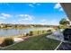 Large backyard with lake access, patio furniture, and grill at 7836 Crosswinds Way, Mount Dora, FL 32757