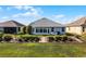 Well-manicured backyard with a sunroom and water views at 7836 Crosswinds Way, Mount Dora, FL 32757