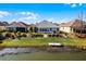 Spacious backyard with water view, landscaping, and patio at 7836 Crosswinds Way, Mount Dora, FL 32757