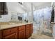 Bathroom features wood cabinets and a marble shower curtain at 7836 Crosswinds Way, Mount Dora, FL 32757