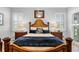 Main bedroom with wood bed frame and blue bedding at 7836 Crosswinds Way, Mount Dora, FL 32757
