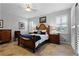 Bedroom with wood bed frame and tile floors at 7836 Crosswinds Way, Mount Dora, FL 32757