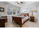 Cozy bedroom with wooden bed frame and window shutters at 7836 Crosswinds Way, Mount Dora, FL 32757
