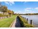 Scenic walking path alongside a lake, offering tranquil community views at 7836 Crosswinds Way, Mount Dora, FL 32757