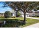 One-story home with a two-car garage, screened lanai, and lush landscaping at 7836 Crosswinds Way, Mount Dora, FL 32757