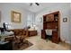 Bright home office features built-in cabinetry and wood desk at 7836 Crosswinds Way, Mount Dora, FL 32757