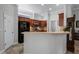 Kitchen boasts dark wood cabinets and granite countertops at 7836 Crosswinds Way, Mount Dora, FL 32757