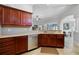 Kitchen features dark wood cabinets and granite countertops at 7836 Crosswinds Way, Mount Dora, FL 32757