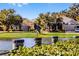 Serene waterfront view with bird perched on a post at 7836 Crosswinds Way, Mount Dora, FL 32757