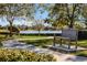 Peaceful lakeside walkway with a bench, offering scenic views at 7836 Crosswinds Way, Mount Dora, FL 32757