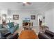 Spacious living room featuring a teal sofa and wood coffee table at 7836 Crosswinds Way, Mount Dora, FL 32757