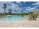 Stunning pool with a relaxing area and palm trees at 7836 Crosswinds Way, Mount Dora, FL 32757