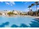Enjoy this relaxing community pool with palm trees at 7836 Crosswinds Way, Mount Dora, FL 32757