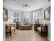 Bright sitting room with beige sofa and wood accents at 7836 Crosswinds Way, Mount Dora, FL 32757